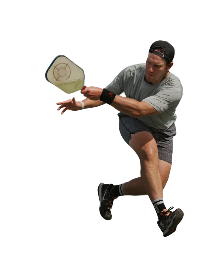 Man playing pickleball with a paddle during an indoor match.