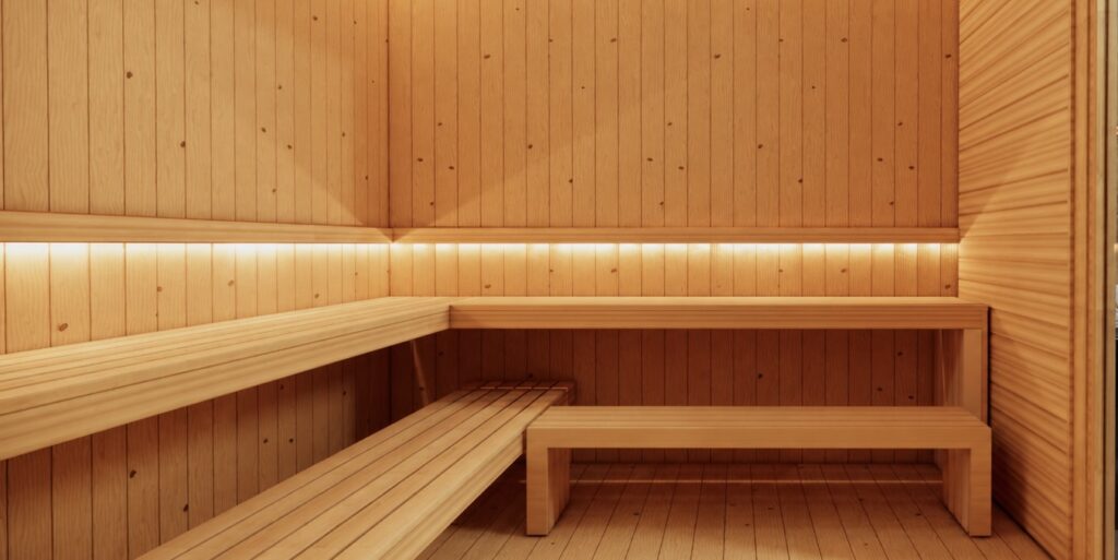 Spacious wooden sauna with bench seating and warm ambient lighting.